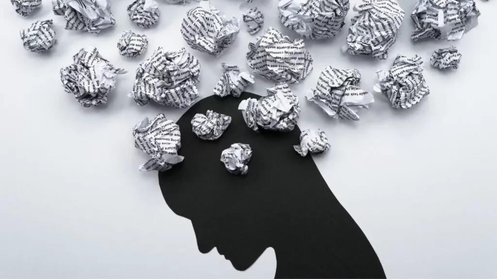 Silhouette With Crumpled Paper Representing Mental Health