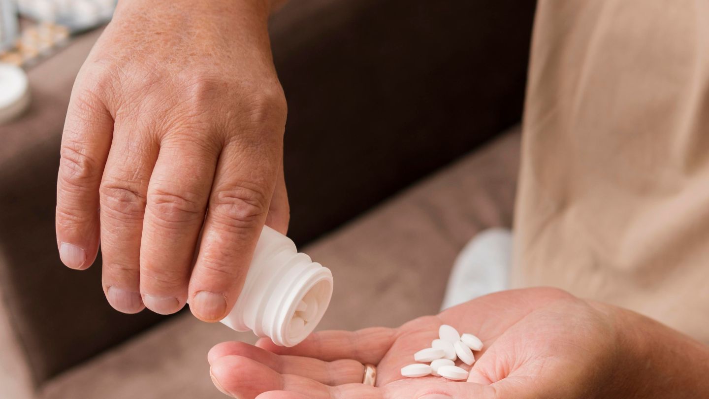 Patient Preparing To Take Prescription Pills 