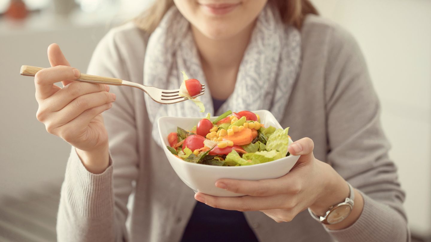 Woman Eating Fresh Vegetable Salad 