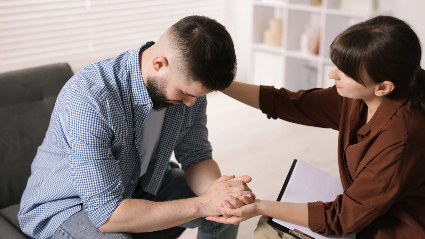 A clinician listens with support as a patient describes what withdrawal has been like